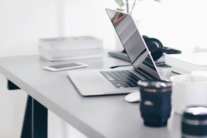 silver macbook pro on gray table