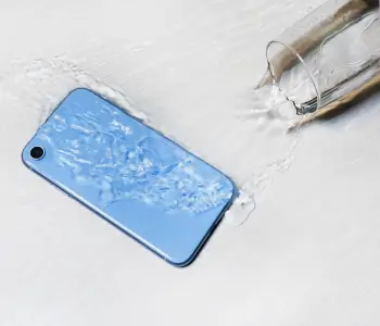 A glass of water spilled on a smartphone