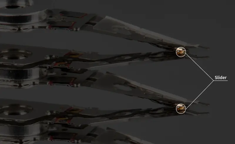 A close-up image of detached read/write heads with a highlight on the slider.