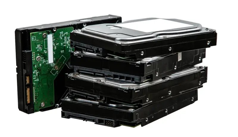 An image of multiple hard drives in a pile.