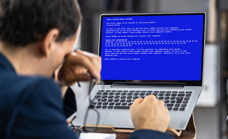 A laptop encounters the Blue Screen of Death on Windows.