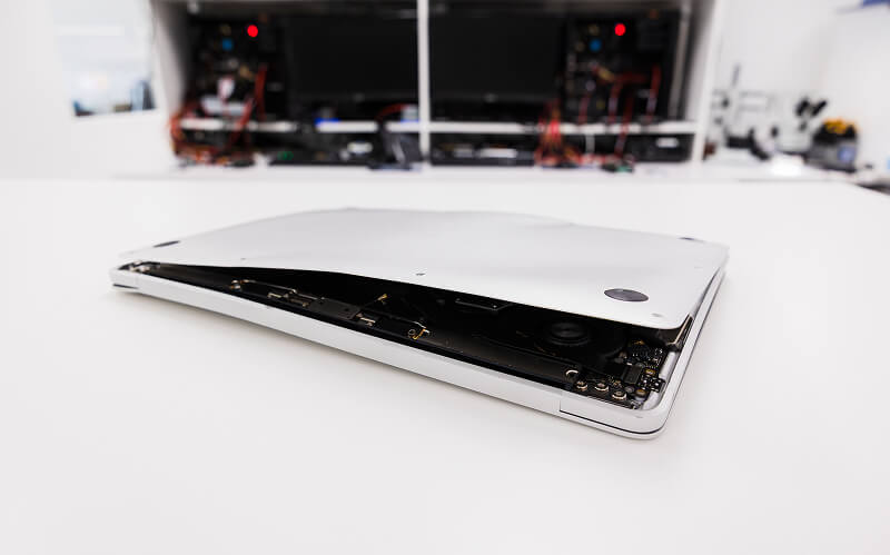 An image of a broken laptop on a workbench in a data recovery cleanroom.