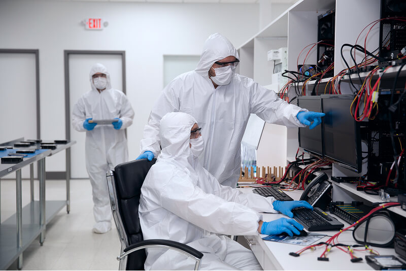 An image of data recovery engineers working on a hard disk drive.