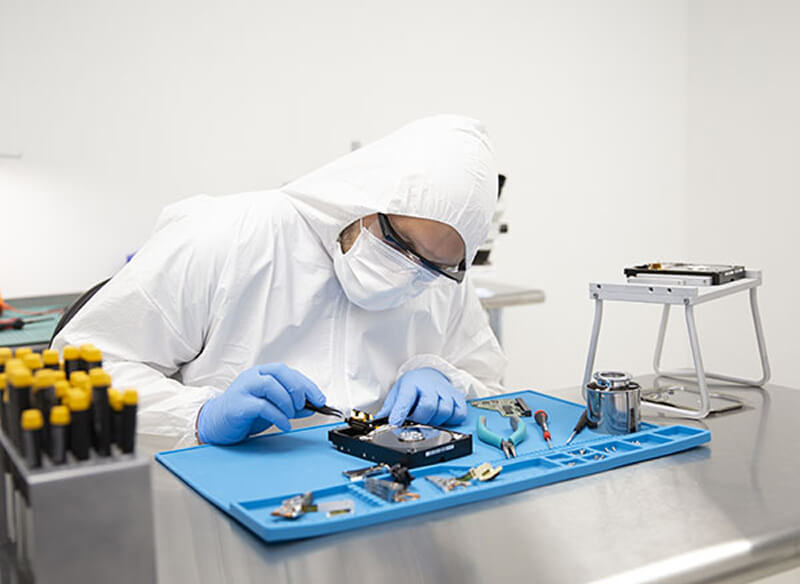 An image of a data recovery specialist fixing a hard drive.