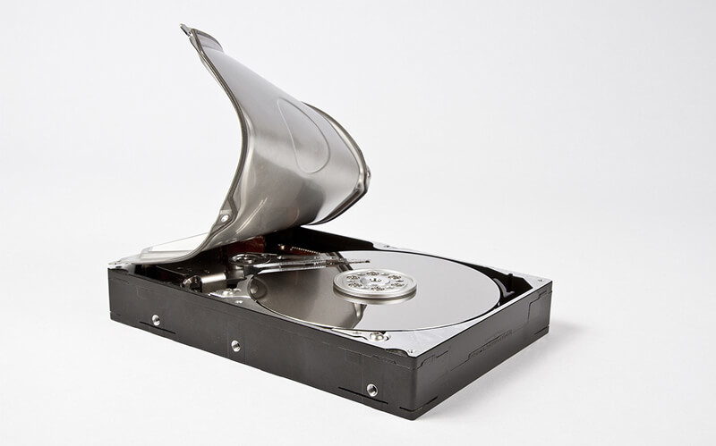 An image of a hard drive’s casing peeled back to reveal magnetic platters.